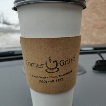 The Corner Grind - a cup of coffee on the dashboard of a car - Coffee & Tea Near Me - Elburn, Illinois