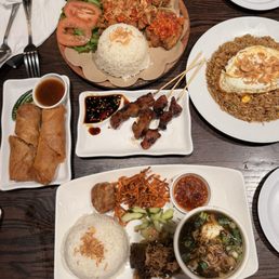 Smashed chicken rice plate, salted fish fried rice, bbq pork sticks, lumpia, beef rice platter with soup.