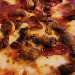 Delicious homemade pizza - pepperoni and mushrooms - they add any toppings you want or choose one of the specialty pizzas on their menu.