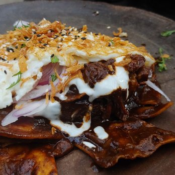 Claro - CHILAQUILES  Short rib, mole negro, fried egg, totopos, crema - Mexican Near Me - Brooklyn, New York
