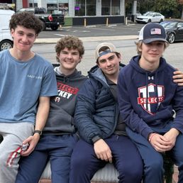 Happily fed hockey players outside of Daddypops