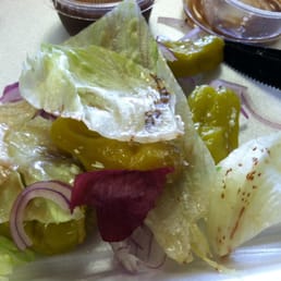 Greek salad served with rotten iceberg lettuce and a piece of onion skin. Greek salad served with rotten iceberg lettuce and a piece of onion skin.