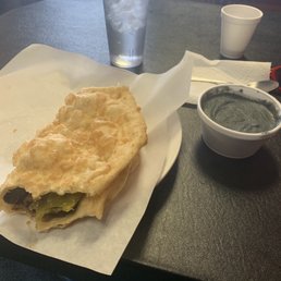 Mutton w/ Green chili in fry bread with a side of blue corn mush Mutton w/ Green chili in fry bread with a side of blue corn mush