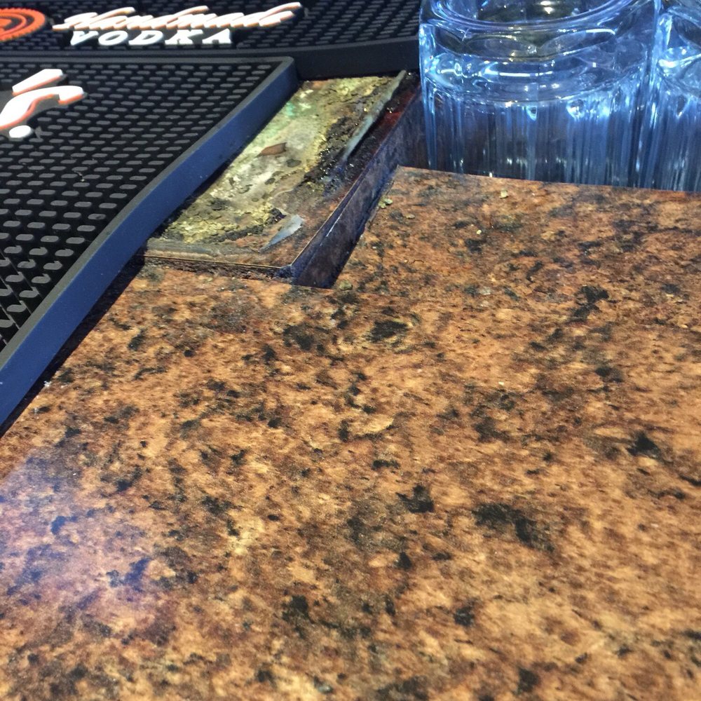 That's mold on the top of the bar where beer taps were located just covered up by a bar mat That's mold on the top of the bar where beer taps were located just covered up by a bar mat