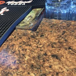 That's mold on the top of the bar where beer taps were located just covered up by a bar mat