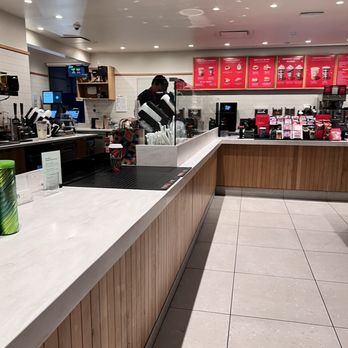 Starbucks - a man standing at a counter in a coffee shop - Coffee & Tea Near Me - San Carlos, California Starbucks - a man standing at a counter in a coffee shop - Coffee & Tea Near Me - San Carlos, California