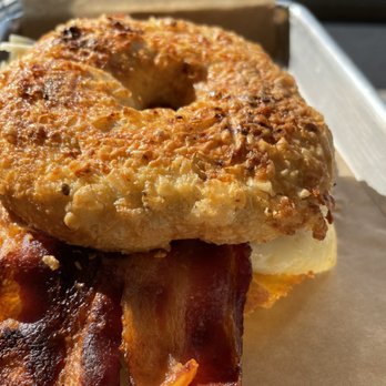 Fletcher Village Bakery - Cheddar-black pepper bagel with egg, bacon, cheddar, and butter - Coffee & Tea Near Me - Fletcher, North Carolina Fletcher Village Bakery - Cheddar-black pepper bagel with egg, bacon, cheddar, and butter - Coffee & Tea Near Me - Fletcher, North Carolina