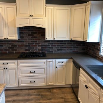 Oaktree Design and Build - a kitchen with white cabinets and black countertops - General Contractors Near Me - Beaumont, California Oaktree Design and Build - a kitchen with white cabinets and black countertops - General Contractors Near Me - Beaumont, California