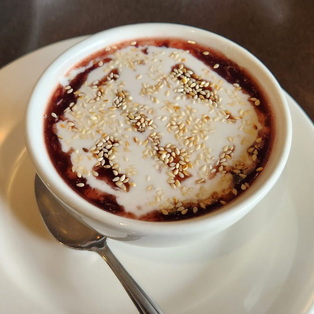 Black rice & coconut milk with sesame seeds sprinkled on top. Black rice & coconut milk with sesame seeds sprinkled on top.