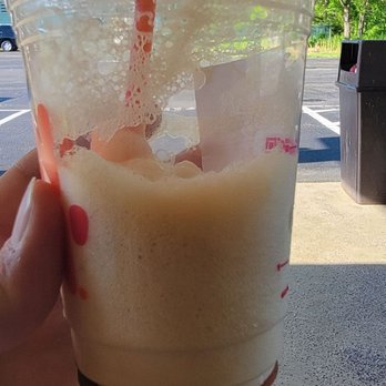 Dunkin' - a hand holding a plastic cup of iced coffee - Donuts Near Me - Delaware Water Gap, Pennsylvania Dunkin' - a hand holding a plastic cup of iced coffee - Donuts Near Me - Delaware Water Gap, Pennsylvania