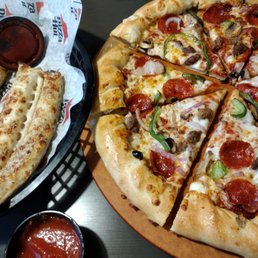 a pizza with pepperoni, mushrooms, and other toppings a pizza with pepperoni, mushrooms, and other toppings