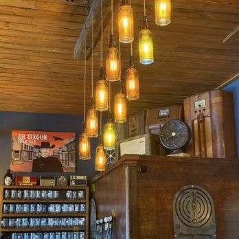 Radio Brewing Company - Lights with bottle casings, radios in the background - New American Near Me - Kellogg, Idaho Radio Brewing Company - Lights with bottle casings, radios in the background - New American Near Me - Kellogg, Idaho