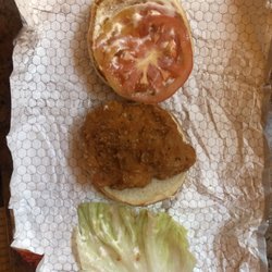 A deconstructed Spicy Chicken sandwich. Cheap iceberg lettuce and thin tomato slices.