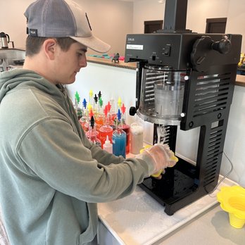 Snug Harbor Trading Post - a man preparing drinks - Shaved Ice Near Me - Muskegon, Michigan Snug Harbor Trading Post - a man preparing drinks - Shaved Ice Near Me - Muskegon, Michigan