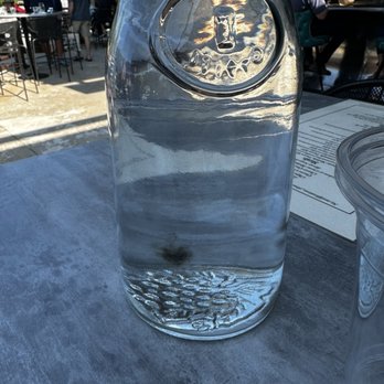 Oro Y Plato - a glass of water on a table - Cocktail Bars Near Me - Bigfork, Montana