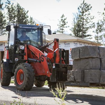 VS Landscape - a tractor with a loader in front of a house - Landscaping Near Me - Ottawa, Ontario VS Landscape - a tractor with a loader in front of a house - Landscaping Near Me - Ottawa, Ontario
