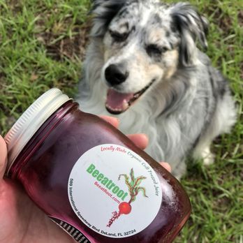 Beeatroot - a hand holding a jar of beet juice - Juice Bars & Smoothies Near Me - DeLand, Florida
