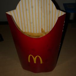 A large order of fries with a small size quantity out of the bag A large order of fries with a small size quantity out of the bag