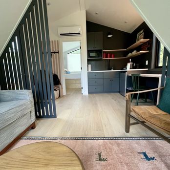 Outbound Stowe - Cabin interior (full kitchen with stovetop and pots pans etc provided); even some original artwork on the shelves - Hotels Near Me - Stowe, Vermont
