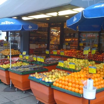 Fresh & Wild - a woman standing in front of a fruit stand - Fruits & Veggies Near Me - Toronto, Ontario Fresh & Wild - a woman standing in front of a fruit stand - Fruits & Veggies Near Me - Toronto, Ontario