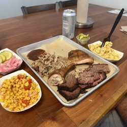 Agape BBQ - 3 Meat Plattee with chili corn salad, pickled onions and pickles, moist brisket, chicken, pulled pork and hatch Mac n cheese