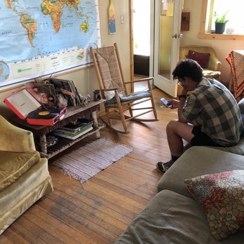 Simple Lodge & Hostel - Living room- front desk books to share, maps and often an album playing on the player, vintage LPs, a big world map and people chatting. - Hostels Near Me - Salida, Colorado Simple Lodge & Hostel - Living room- front desk books to share, maps and often an album playing on the player, vintage LPs, a big world map and people chatting. - Hostels Near Me - Salida, Colorado