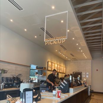 Starbucks - a man working behind the counter in a coffee shop - Coffee & Tea Near Me - Kansas City, Missouri Starbucks - a man working behind the counter in a coffee shop - Coffee & Tea Near Me - Kansas City, Missouri