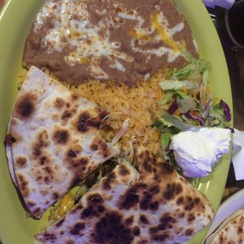 Zarape - Steak quesadilla - The image shows a plate with quesadillas, rice, a side salad, and sour cream, served on a green tray. - Mexican Near Me - Marlborough, Massachusetts
