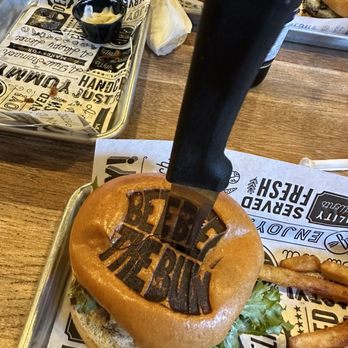 Between The Bun - a burger with a knife sticking out of it - American Near Me - North Ridgeville, Ohio Between The Bun - a burger with a knife sticking out of it - American Near Me - North Ridgeville, Ohio