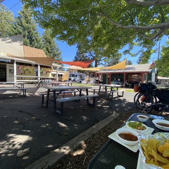Eurosports - a table of food and a bicycle parked in front of a restaurant - Bikes Near Me - Sisters, Oregon Eurosports - a table of food and a bicycle parked in front of a restaurant - Bikes Near Me - Sisters, Oregon