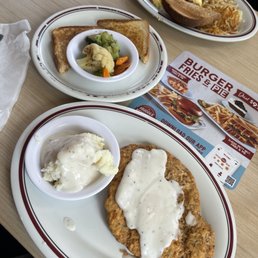Country fried steak and gravy with mashed potatoes and vegetables Country fried steak and gravy with mashed potatoes and vegetables