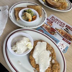 Huddle House - Country fried steak and gravy with mashed potatoes and vegetables