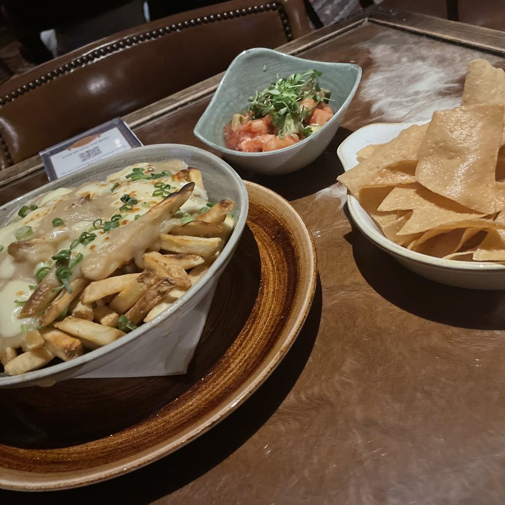 The Driskill - Poutine fries at Driskill bar and shrimp tostada dip - Hotels Near Me - Austin, Texas The Driskill - Poutine fries at Driskill bar and shrimp tostada dip - Hotels Near Me - Austin, Texas