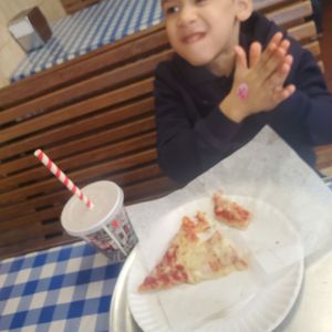 Photo of John & Joe's Pizzeria - Bronx, NY, United States. Can you tell just hiw much he loves this pizza!!!