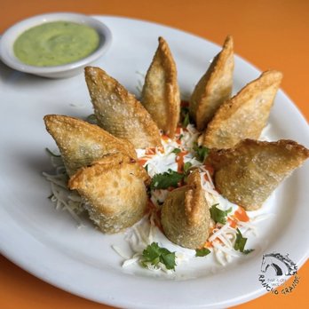 Rancho Grande - Crispy empanadas stuffed with shredded chicken, spinach, and shredded cheese, served over a bed of sour cream. - Mexican Near Me - Conroe, Texas Rancho Grande - Crispy empanadas stuffed with shredded chicken, spinach, and shredded cheese, served over a bed of sour cream. - Mexican Near Me - Conroe, Texas