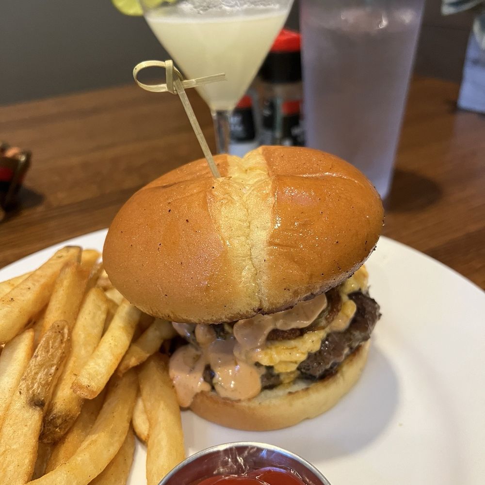 Smash burger with Cajun fries and a lemon drop martini Smash burger with Cajun fries and a lemon drop martini