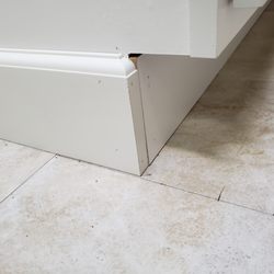 KB Design Solutions - The foot kick under the trash cabinet is misaligned (not flush) with the adjacent cabinet. See Figure 2a. Notice the gap.