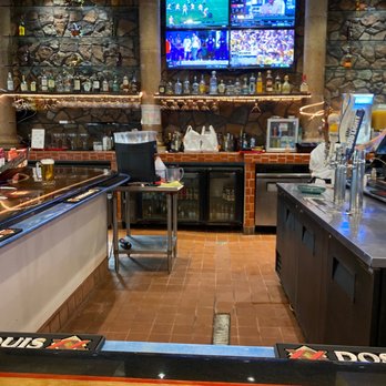 Don Carlos - a view of a bar with a television in the background - Mexican Near Me - Daphne, Alabama