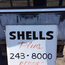 Shells Plus - Small sign located on the corner of the business.