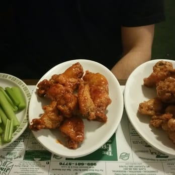 The Evening Post Bar & Grill - two plates of chicken wings and celery - American Near Me - Clare, Michigan The Evening Post Bar & Grill - two plates of chicken wings and celery - American Near Me - Clare, Michigan