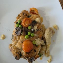 Breaded Chicken special with peas, mushrooms and tomatoes on top of mashed potatoes!
