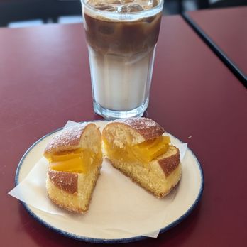 Seara Bakery & Pastry - Iced latte with a Portuguese vanilla custard-filled donut - Coffee & Tea Near Me - Vaughan, Ontario Seara Bakery & Pastry - Iced latte with a Portuguese vanilla custard-filled donut - Coffee & Tea Near Me - Vaughan, Ontario