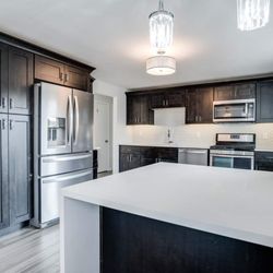 Stetor Remodeling - Kitchen remodeled with plywood cabinets that have soft closing hardware, quartz countertops, vinyl plank flooring, and stainl...