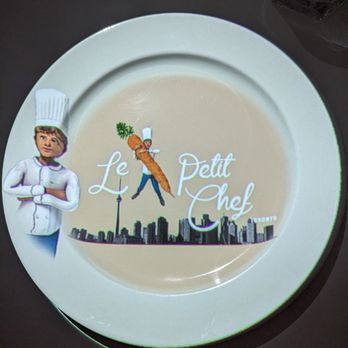Le Petit Chef - a chef holding a carrot - French Near Me - Toronto, Ontario Le Petit Chef - a chef holding a carrot - French Near Me - Toronto, Ontario