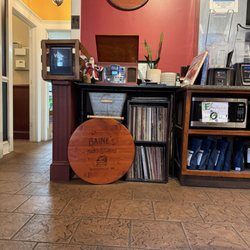 Baine's Books & Coffee - Music player with records and wooden signs reading "Butter Beer" and "Bain's Books & Coffee Scottsville, VA"