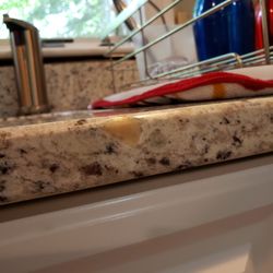 Design's Kitchen & Bath Center - Granite was damaged. They tried patching hole but grout is orange.