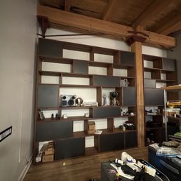 Custom walnut book cases with integrated lighting, cabinets and drawers
