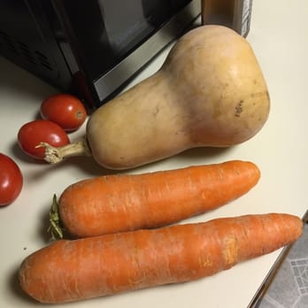 Holmberg Orchards - My HUGE carrots next to some roma tomatoes and a squash for comparison. HUGE. - Fruits & Veggies Near Me - Gales Ferry, Connecticut