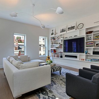 NY Construction And Stone - a living room with bookshelves - General Contractors Near Me - Long Island City, New York NY Construction And Stone - a living room with bookshelves - General Contractors Near Me - Long Island City, New York
