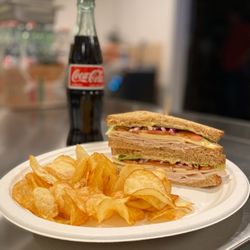 El Dicho Café - Club sandwich with chips and soda.